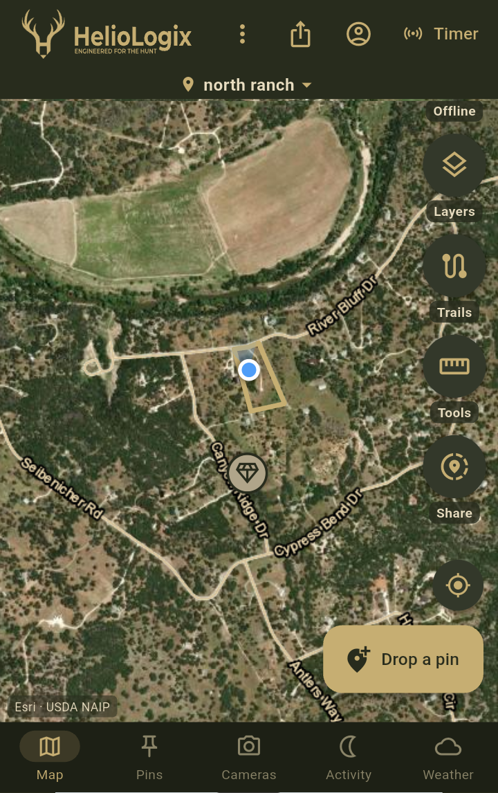 HelioMaps app showing a ranch boundary, roads, and a feeder pin on satellite imagery